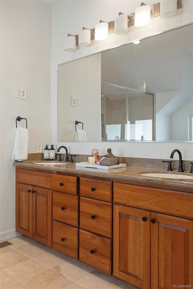 bathroom featuring vanity, tile patterned floors, and walk in shower