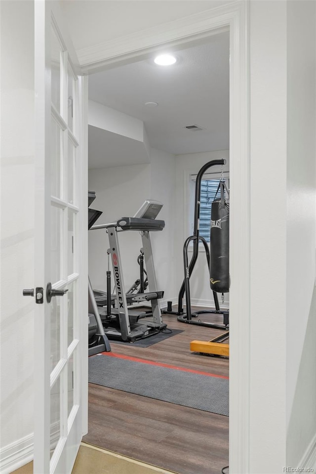 exercise room with hardwood / wood-style flooring