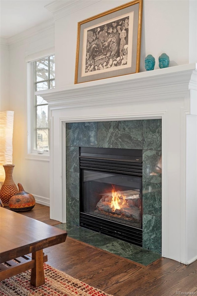 interior details with crown molding, a fireplace, and hardwood / wood-style floors