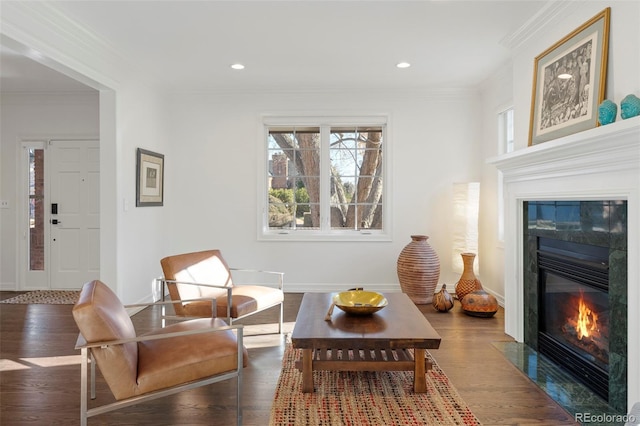 sitting room with dark hardwood / wood-style floors and crown molding