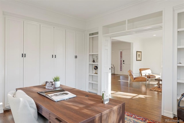 office area featuring dark hardwood / wood-style flooring, built in features, and ornamental molding