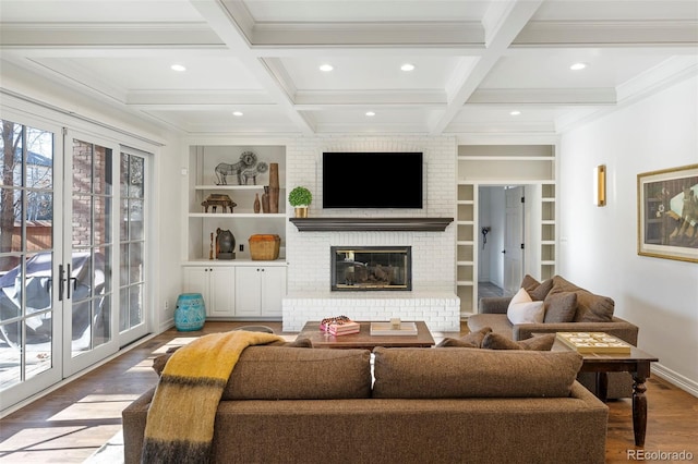 living room with hardwood / wood-style flooring, built in shelves, beam ceiling, and coffered ceiling