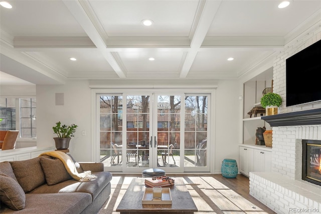 living room with beam ceiling, coffered ceiling, and a brick fireplace