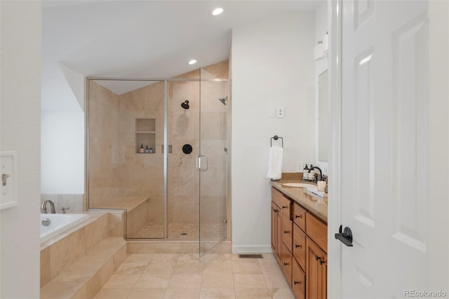 bathroom featuring tile patterned flooring, vanity, and independent shower and bath