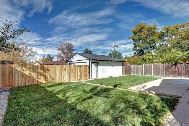 view of yard featuring a patio area, a fenced backyard, and an outdoor structure