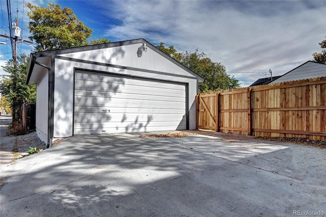 detached garage featuring fence