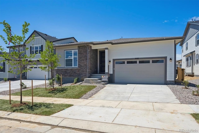 9061 Telluride Ct, Commerce City, CO 80022 - view of front facade featuring driveway, a garage, and board and batten siding