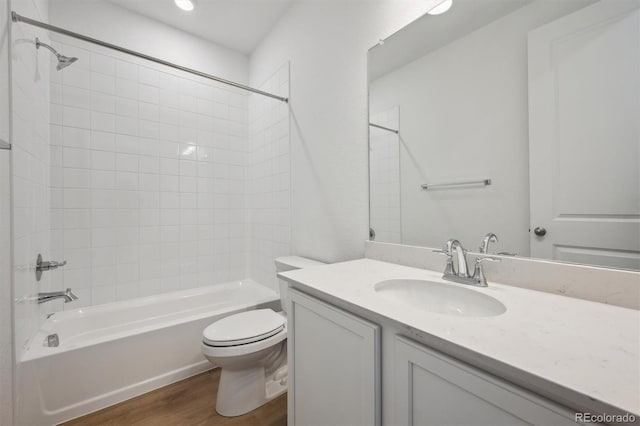 9061 Telluride Ct, Commerce City, CO 80022 - full bath featuring toilet, vanity, bathing tub / shower combination, and wood finished floors