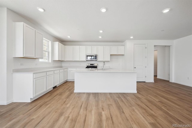9061 Telluride Ct, Commerce City, CO 80022 - kitchen featuring stainless steel appliances, white cabinetry, a sink, and recessed lighting