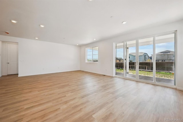 9061 Telluride Ct, Commerce City, CO 80022 - spare room featuring light wood-style floors, baseboards, and recessed lighting