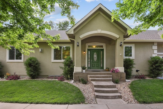 1235 S Balsam St, Lakewood, CO 80232 - view of front of property with stucco siding, a front lawn, and a shingled roof