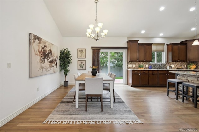 1235 S Balsam St, Lakewood, CO 80232 - dining space featuring a chandelier, light wood finished floors, recessed lighting, baseboards, and vaulted ceiling