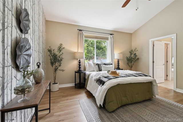 1235 S Balsam St, Lakewood, CO 80232 - bedroom with light wood finished floors, baseboards, vaulted ceiling, and a ceiling fan