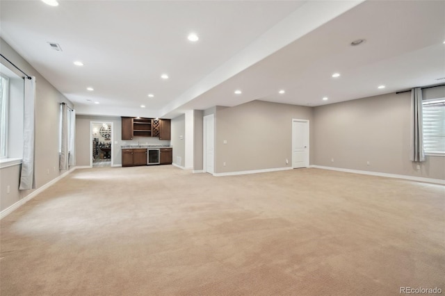 1235 S Balsam St, Lakewood, CO 80232 - unfurnished living room featuring beverage cooler, light carpet, recessed lighting, and baseboards