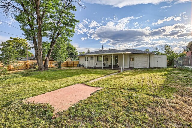 2996 S Sheridan Blvd, Denver, CO 80227 - back of property featuring a fenced backyard and a patio