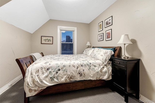 carpeted bedroom featuring baseboards and vaulted ceiling