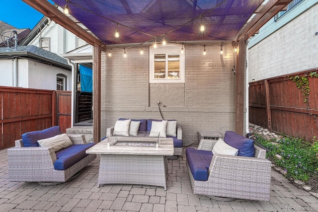 view of patio with an outdoor living space with a fire pit and a fenced backyard