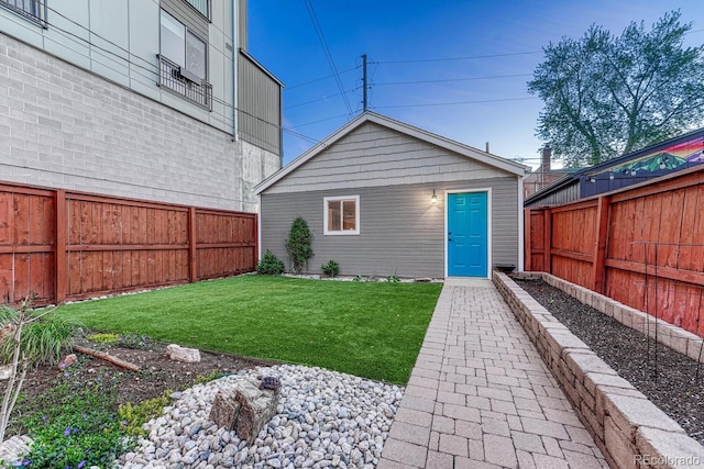 exterior space with an outdoor structure and a fenced backyard