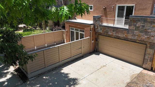 467 Harrison St, Denver, CO 80206 - exterior space with stucco siding, an attached garage, and driveway