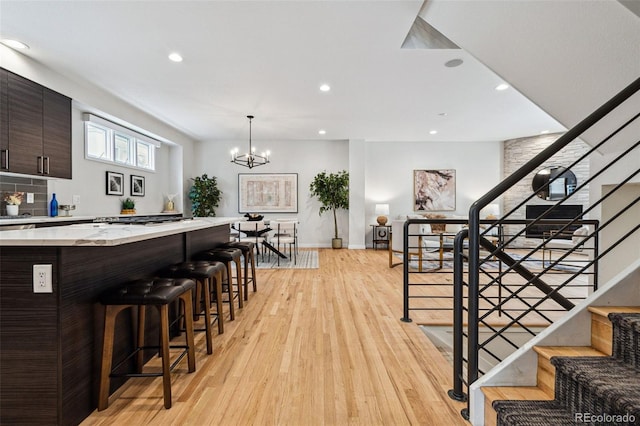 467 Harrison St, Denver, CO 80206 - staircase featuring wood finished floors, recessed lighting, and a chandelier