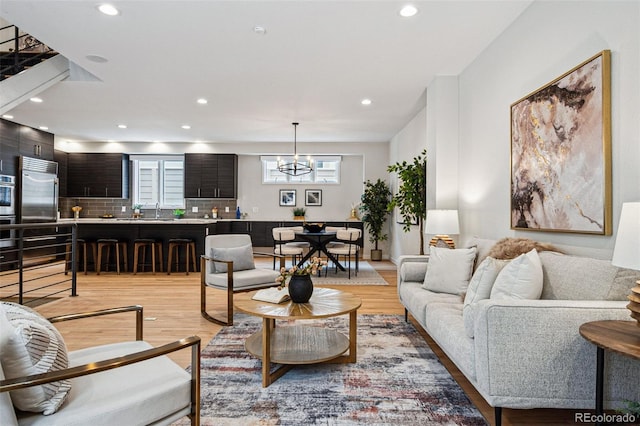 467 Harrison St, Denver, CO 80206 - living room featuring light wood-style floors, a chandelier, and recessed lighting