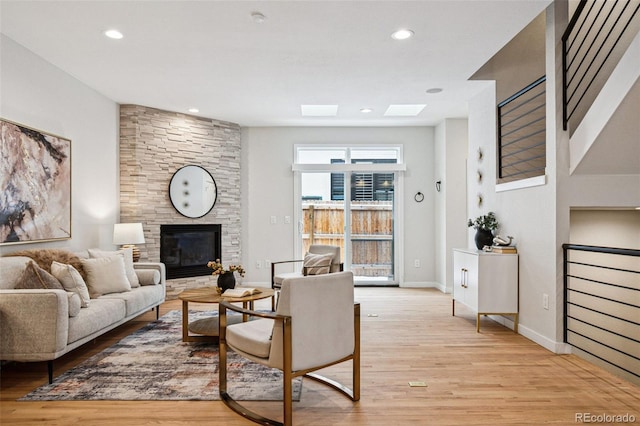 467 Harrison St, Denver, CO 80206 - living area featuring light wood-type flooring, a skylight, a fireplace, and recessed lighting
