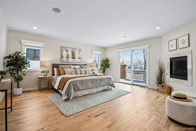 467 Harrison St, Denver, CO 80206 - bedroom with access to exterior, light wood-type flooring, a fireplace, and recessed lighting