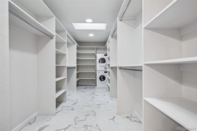 467 Harrison St, Denver, CO 80206 - spacious closet featuring estacked washer and dryer, marble finish flooring, and a skylight