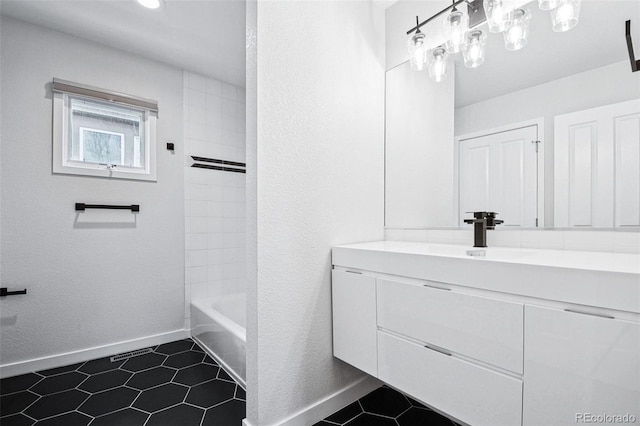 467 Harrison St, Denver, CO 80206 - bathroom featuring vanity, tile patterned floors, bathtub / shower combination, and a textured wall