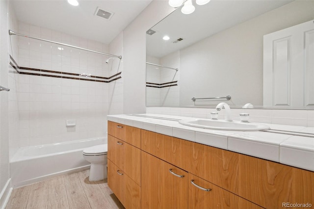 467 Harrison St, Denver, CO 80206 - full bathroom with wood finished floors, vanity, washtub / shower combination, and recessed lighting