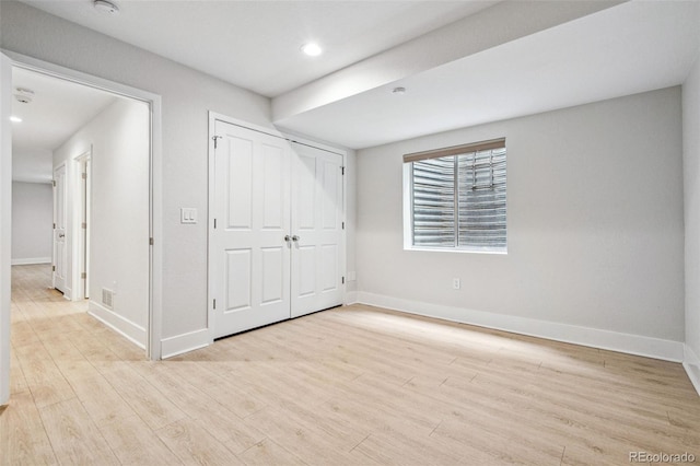 467 Harrison St, Denver, CO 80206 - unfurnished bedroom with light wood-style flooring, recessed lighting, and a closet