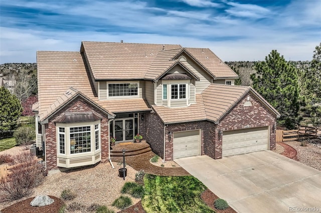 6013 S Kittredge Ct, Centennial, CO 80016 - view of front of house with brick siding, a tiled roof, and concrete driveway