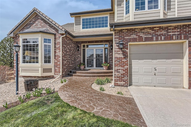 6013 S Kittredge Ct, Centennial, CO 80016 - view of front facade with brick siding, driveway, french doors, and a garage