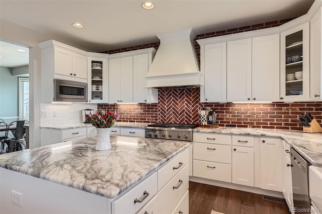 6013 S Kittredge Ct, Centennial, CO 80016 - kitchen featuring custom exhaust hood, white cabinets, and stainless steel appliances
