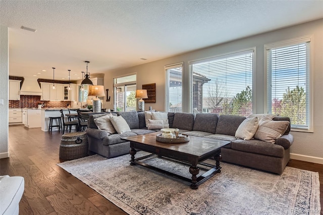 6013 S Kittredge Ct, Centennial, CO 80016 - living room with a textured ceiling, baseboards, visible vents, and dark wood-style floors