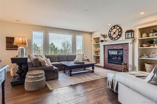6013 S Kittredge Ct, Centennial, CO 80016 - living room with dark wood-style flooring, a fireplace, a textured ceiling, built in shelves, and recessed lighting