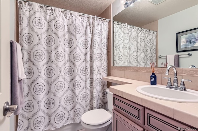 6013 S Kittredge Ct, Centennial, CO 80016 - full bath with a shower with curtain, decorative backsplash, a textured ceiling, vanity, and toilet