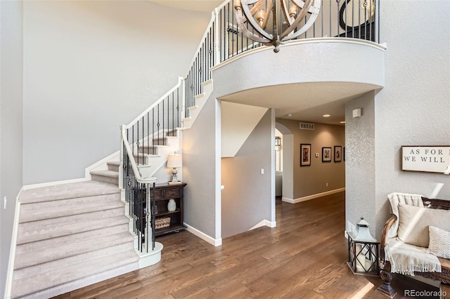 6013 S Kittredge Ct, Centennial, CO 80016 - stairway with arched walkways, baseboards, wood finished floors, and visible vents