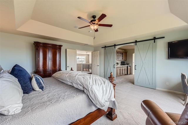6013 S Kittredge Ct, Centennial, CO 80016 - bedroom featuring light carpet, baseboards, a barn door, a raised ceiling, and a ceiling fan