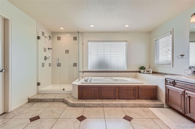 6013 S Kittredge Ct, Centennial, CO 80016 - bathroom featuring recessed lighting, a shower stall, a garden tub, and vanity
