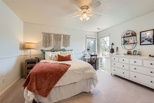 6013 S Kittredge Ct, Centennial, CO 80016 - bedroom featuring ceiling fan, a textured ceiling, visible vents, baseboards, and light carpet