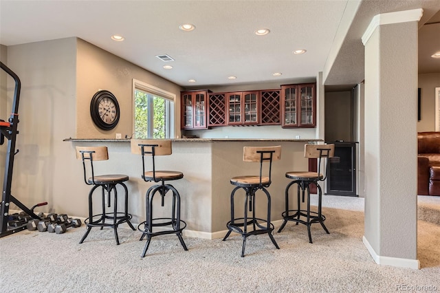 6013 S Kittredge Ct, Centennial, CO 80016 - bar featuring recessed lighting, wet bar, visible vents, and light carpet