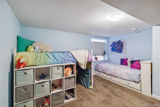 carpeted bedroom featuring a textured ceiling