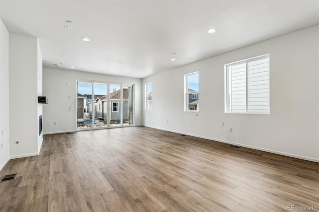 unfurnished living room with light wood-type flooring