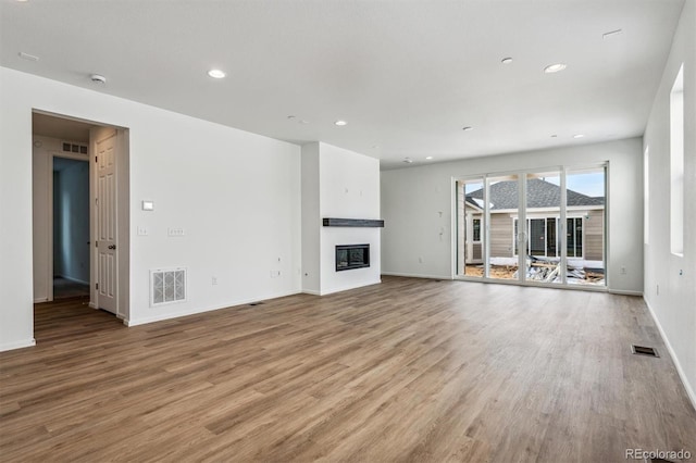 unfurnished living room featuring light hardwood / wood-style floors