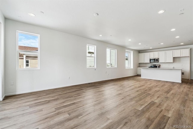 unfurnished living room featuring light hardwood / wood-style floors