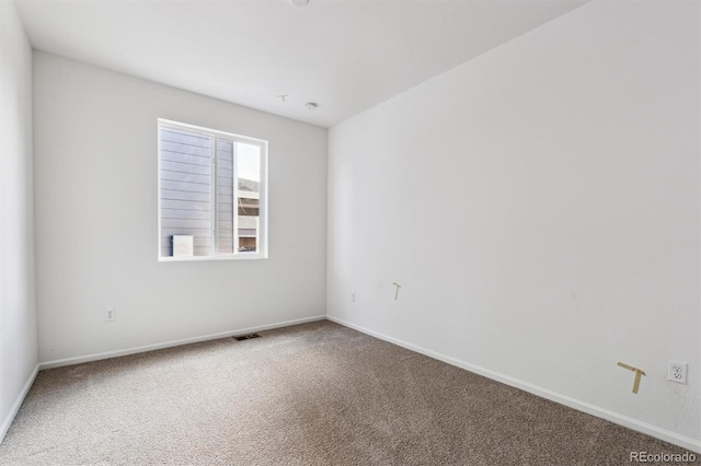 unfurnished room featuring carpet