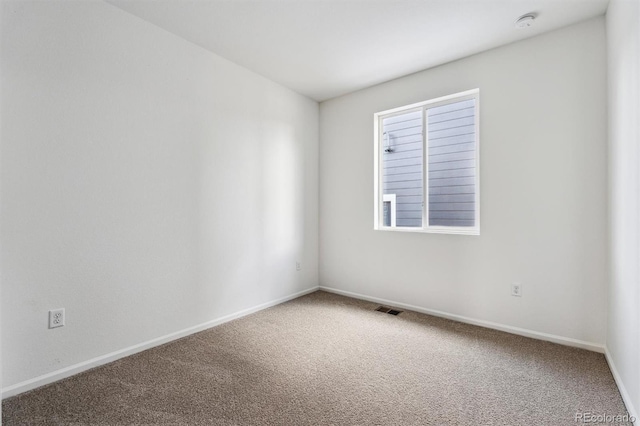 spare room featuring carpet