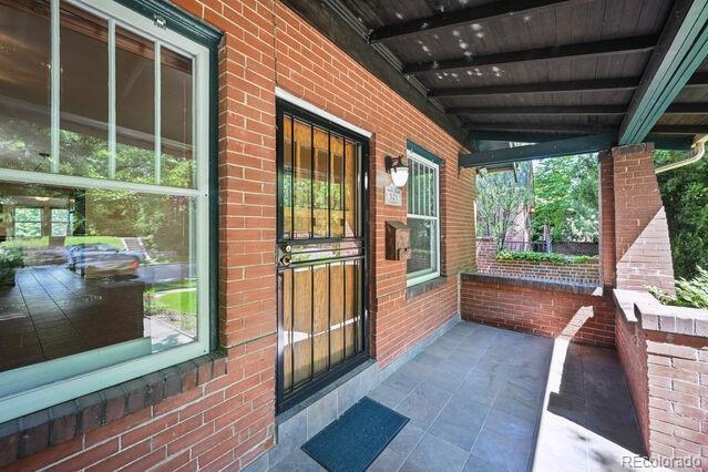321 S Gilpin St, Denver, CO 80209 - property entrance with covered porch and brick siding