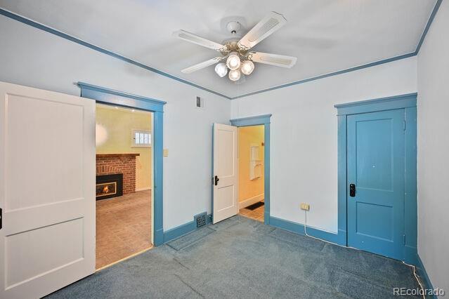321 S Gilpin St, Denver, CO 80209 - unfurnished bedroom featuring carpet, a fireplace, and ceiling fan